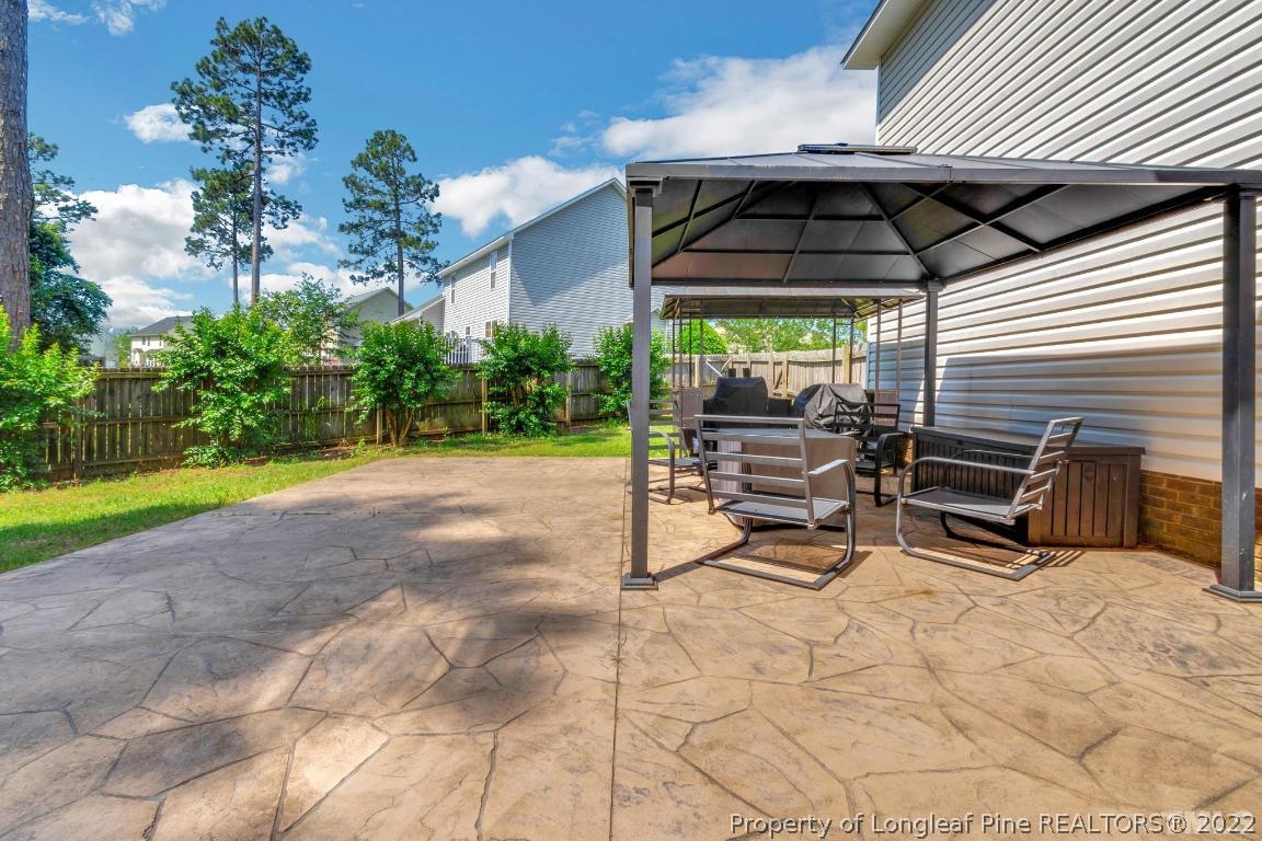 226 Linden Road Cameron, NC 28326 - Photo 33 of 36 a view of a chairs and table in the back yard of the house