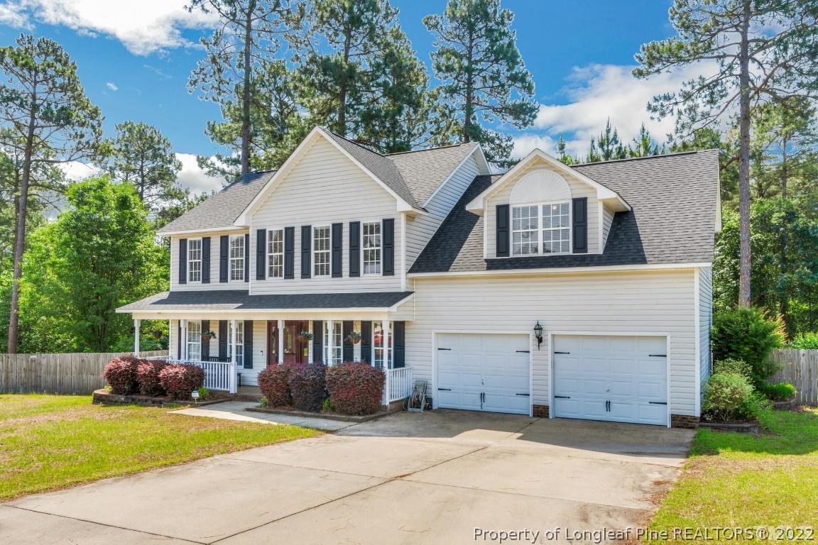 226 Linden Road Cameron, NC 28326 - Photo 4 of 36 a front view of a house with a garden and trees
