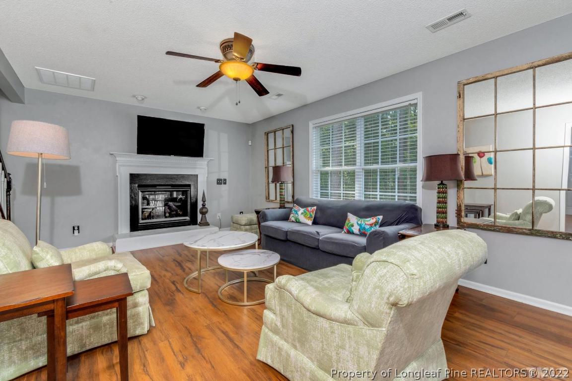 226 Linden Road Cameron, NC 28326 - Photo 7 of 36 a living room with fireplace furniture and a flat screen tv