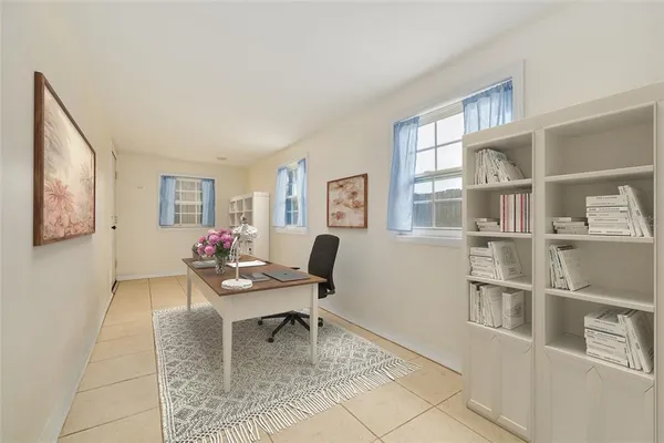 a living room with furniture a rug and a window