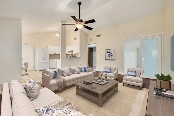 a living room with furniture ceiling fan and a rug