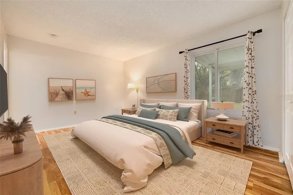 a bedroom with a bed and a potted plant