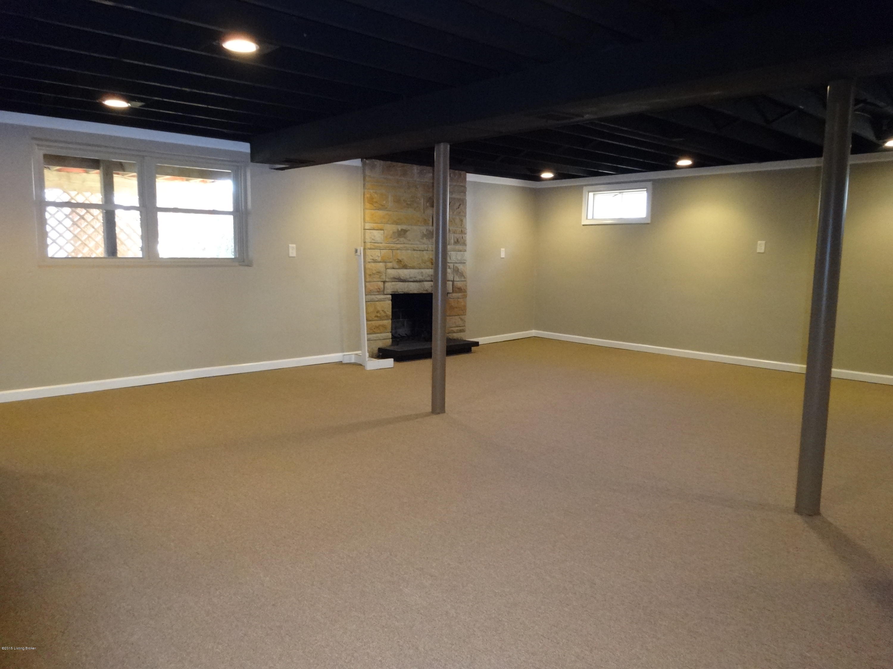 4402 Lowe Road Louisville, KY 40220 - Photo 5 of 44 Family Room w/ Fireplace in Walkout Basement! Professionally Painted Ceiling w/ RECESSED LIGHTING Separate living Quarter Suite w/ Bedroom, office, & Full Bath! Bmt also has a buffet room!