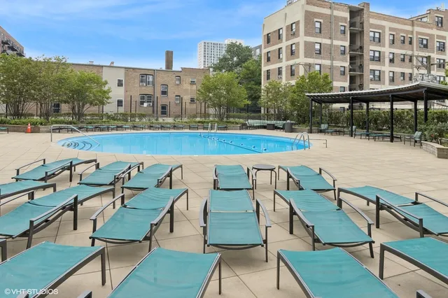 a view of swimming pool with outdoor seating and city view