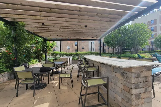 a view of a patio with table and chairs