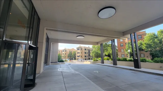 a view of hallway with furniture and floor to ceiling window
