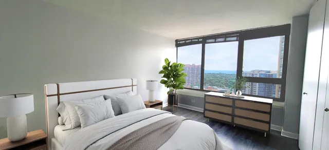 a bedroom with a bed and a large window