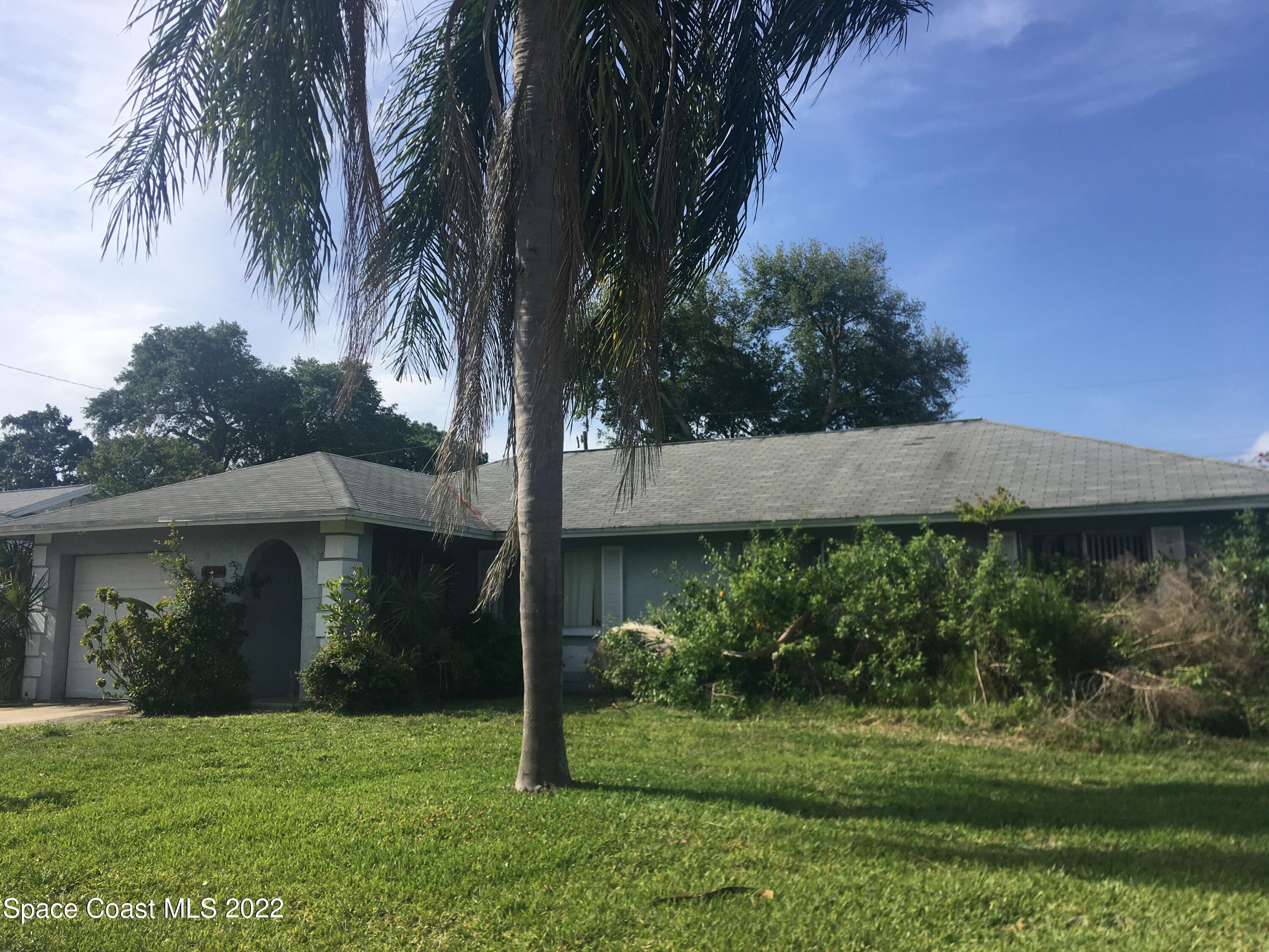 1118 Manatee Drive Rockledge, FL 32955 - Photo 1 of 8 a view of a house with a yard