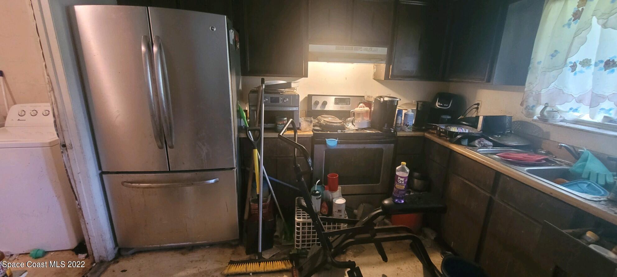 1118 Manatee Drive Rockledge, FL 32955 - Photo 3 of 8 a kitchen with a refrigerator and a refrigerator