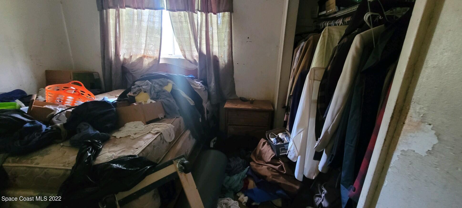 1118 Manatee Drive Rockledge, FL 32955 - Photo 6 of 8 a view of walk in closet with clothes