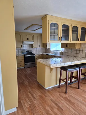 a kitchen with stainless steel appliances granite countertop a stove and a refrigerator