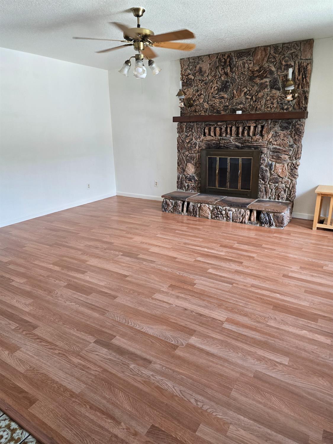 649 Sycamore Avenue Gustine, CA 95322 - Photo 4 of 12 a view of a livingroom with wooden floor and a fireplace