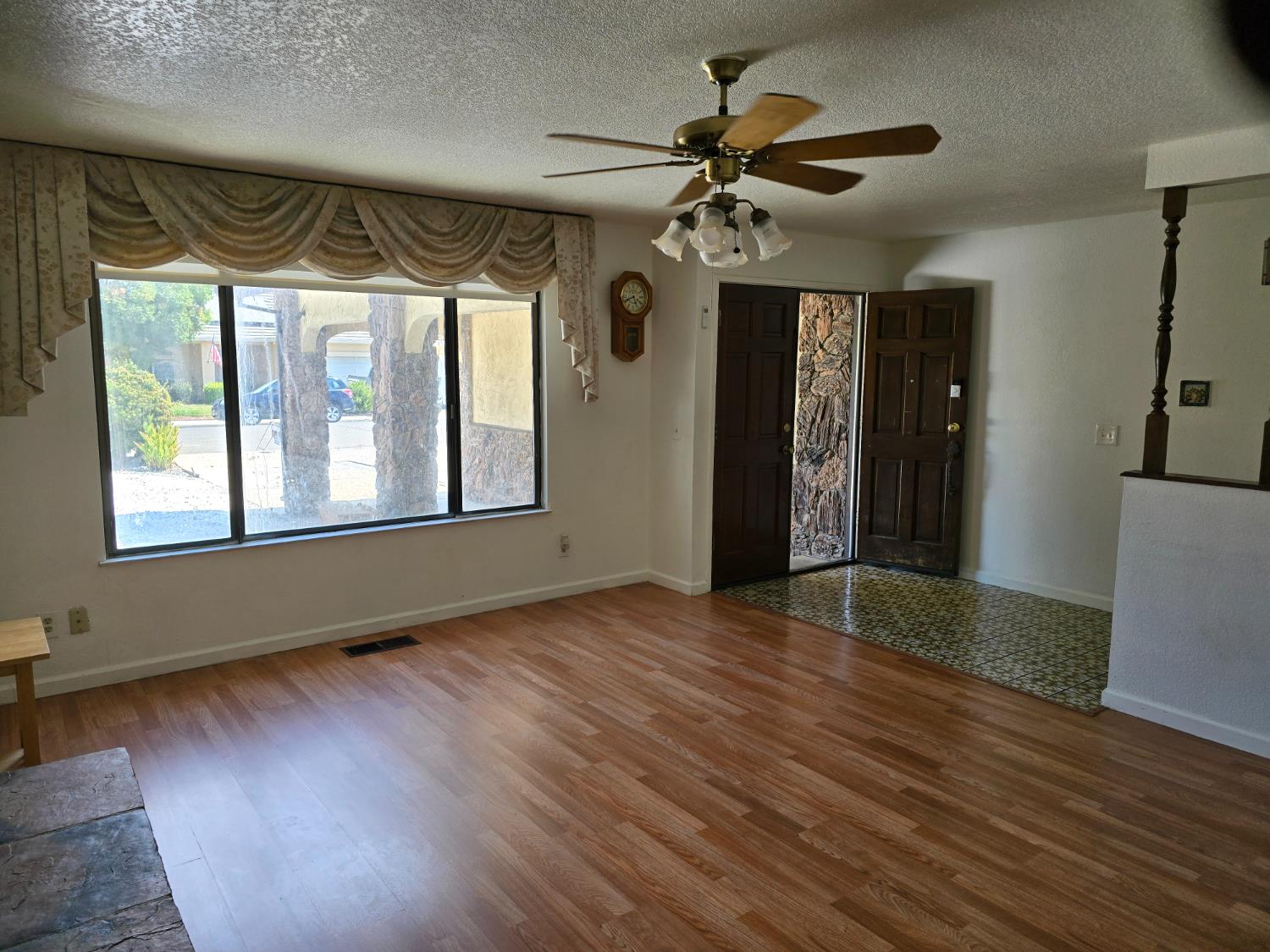 649 Sycamore Avenue Gustine, CA 95322 - Photo 6 of 12 a view of an empty room with a window and wooden floor