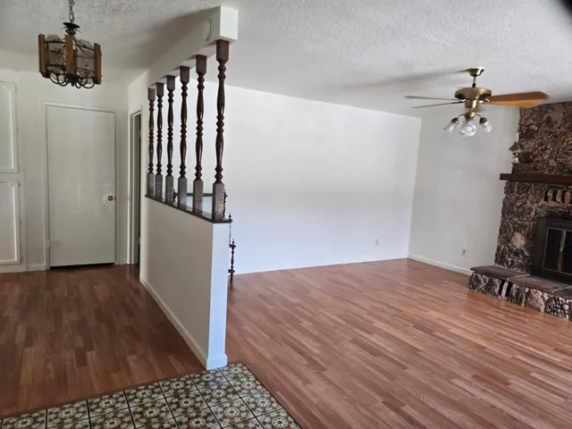 a view of hallway with wooden floor and stairs