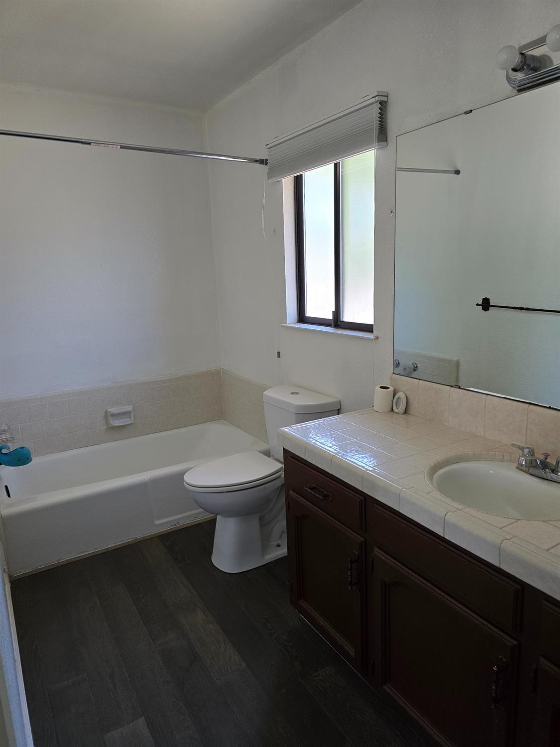 649 Sycamore Avenue Gustine, CA 95322 - Photo 10 of 12 a bathroom with a granite countertop sink a toilet and bathtub