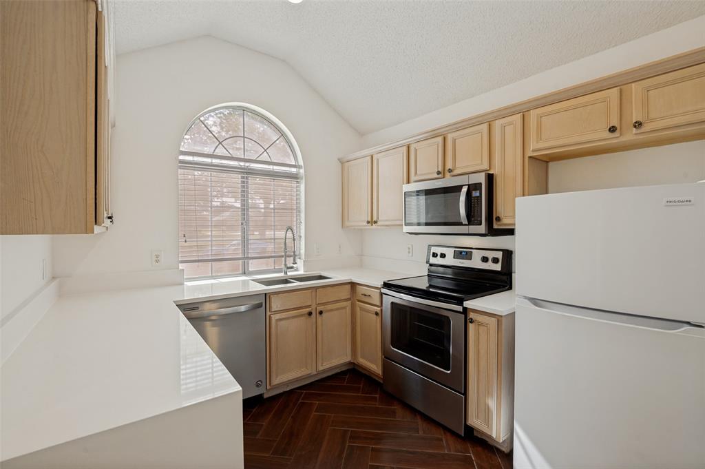 8160 Tower Road Frisco, TX 75035 - Photo 6 of 25 a kitchen with stainless steel appliances granite countertop a stove a sink and a microwave