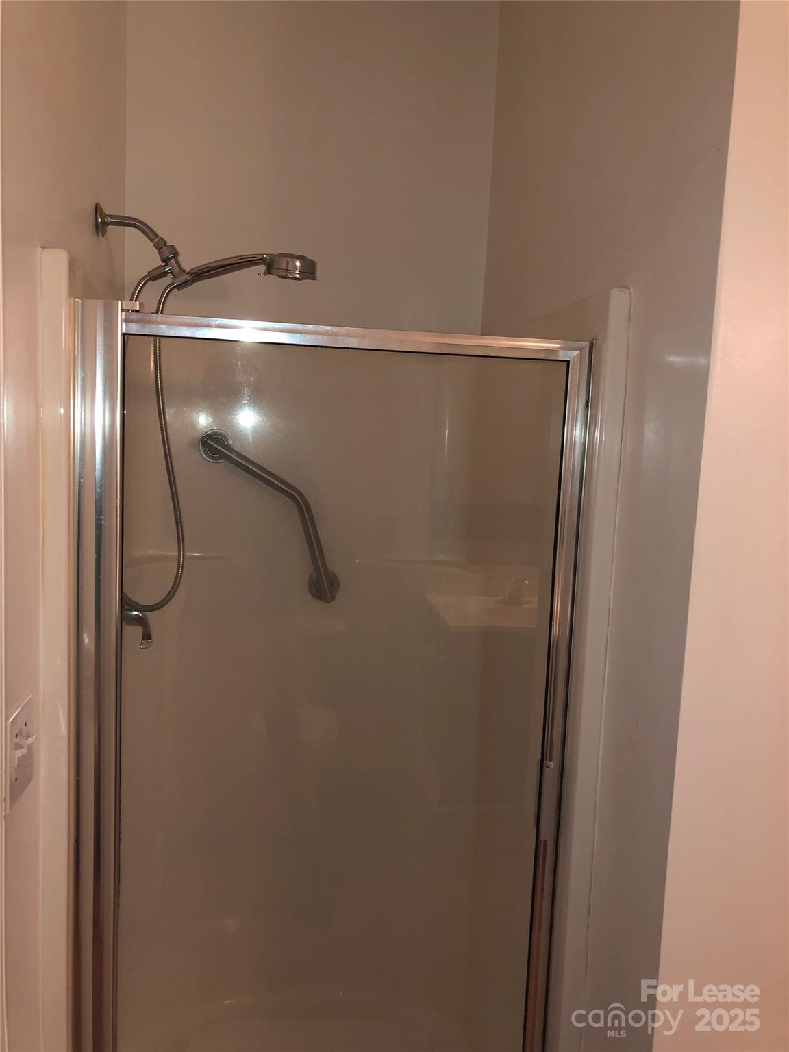 21253 Hickory Street Cornelius, NC 28031 - Photo 12 of 17 a bathroom with a glass shower door