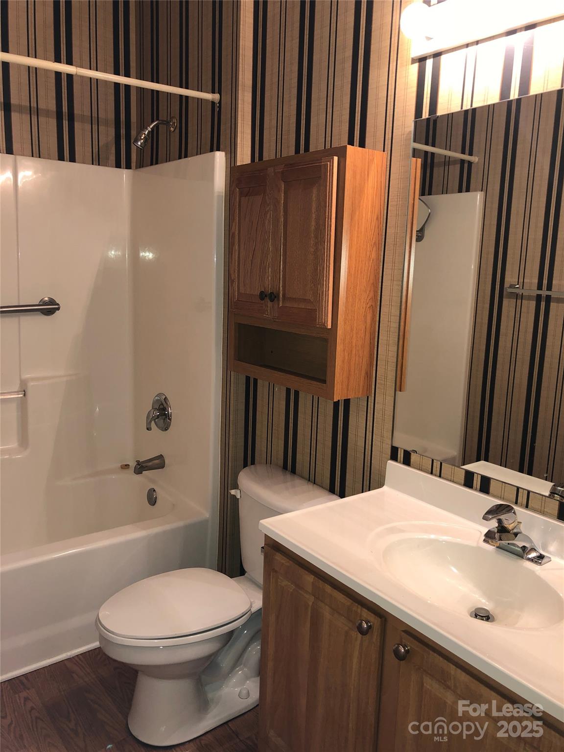 21253 Hickory Street Cornelius, NC 28031 - Photo 14 of 17 a bathroom with a sink a toilet and shower