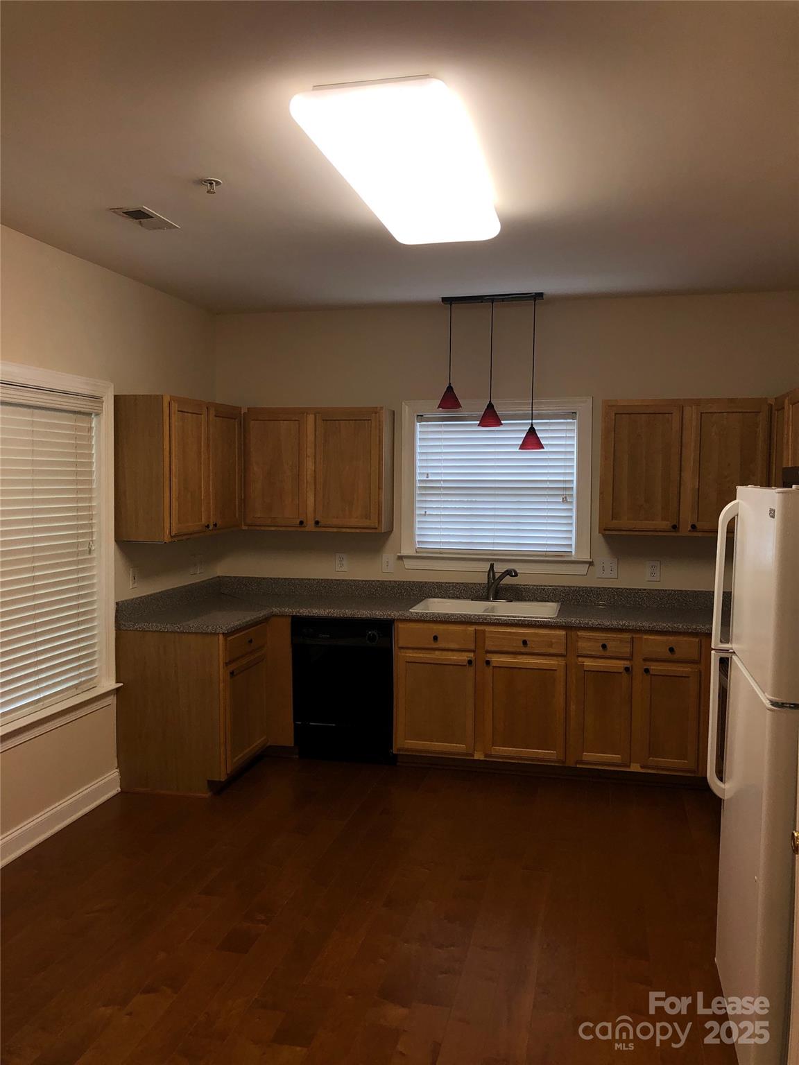 21253 Hickory Street Cornelius, NC 28031 - Photo 4 of 17 a kitchen with granite countertop a refrigerator and a stove