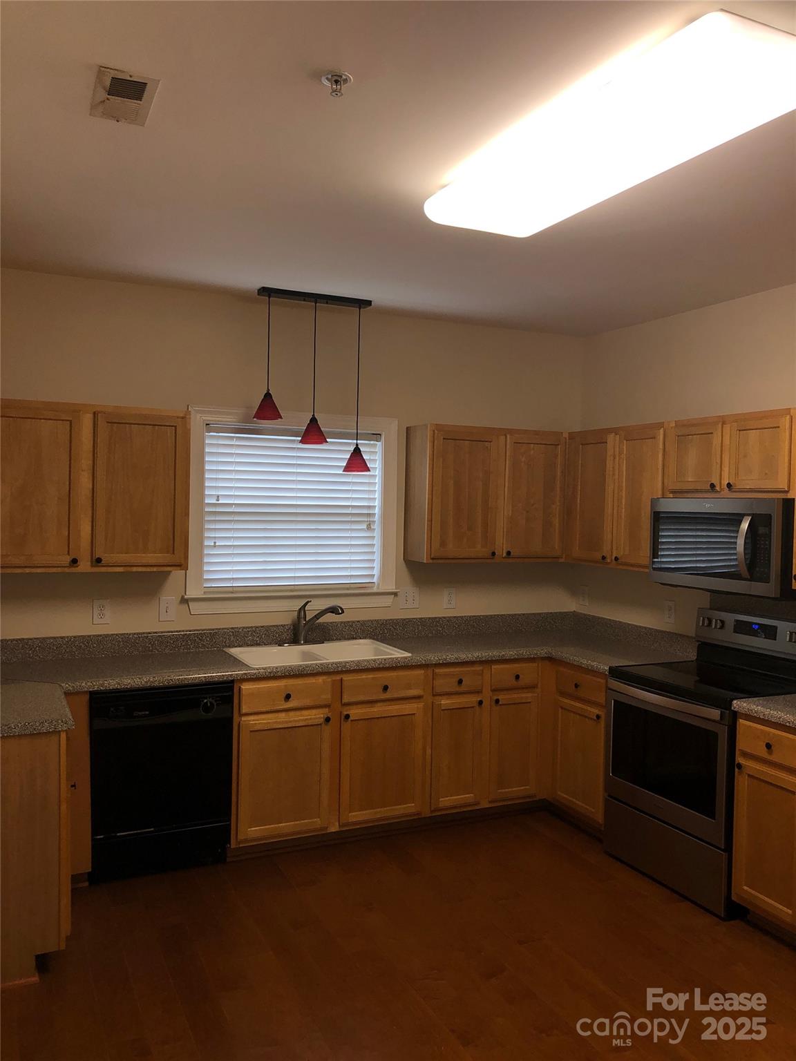 21253 Hickory Street Cornelius, NC 28031 - Photo 5 of 17 a kitchen with granite countertop a sink and cabinets