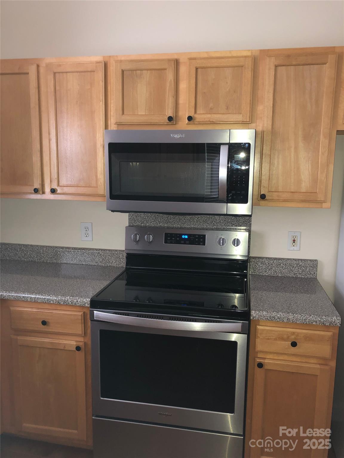21253 Hickory Street Cornelius, NC 28031 - Photo 7 of 17 a kitchen with granite countertop cabinets stove and microwave
