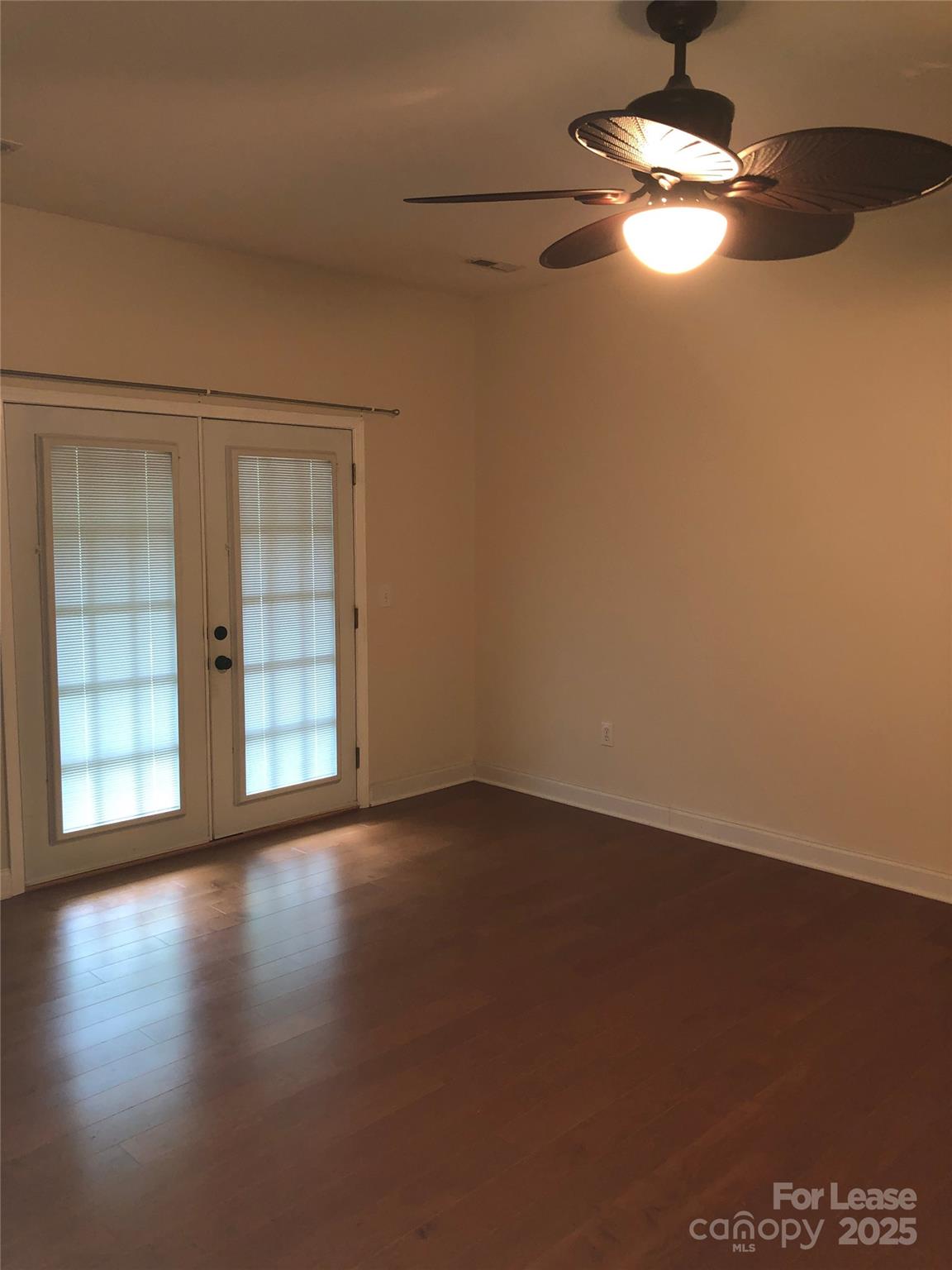 21253 Hickory Street Cornelius, NC 28031 - Photo 10 of 17 a view of an empty room with wooden floor and a window