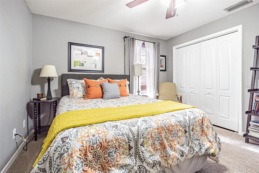 9809 La Rita Place Riverview, FL 33569 - Photo 20 of 59 a bedroom with a bed and a lamp