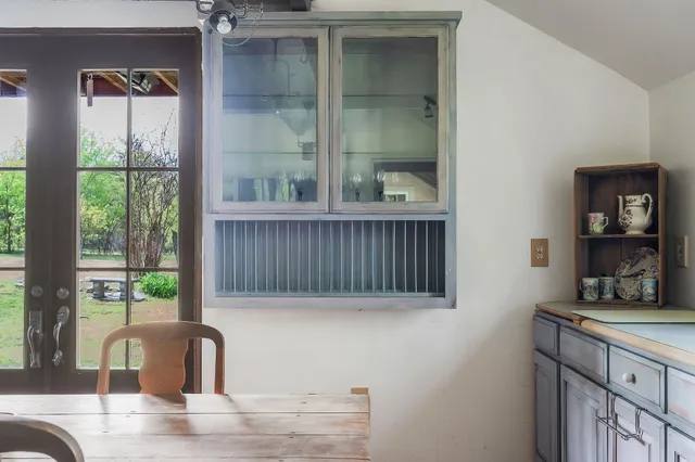 a kitchen with a window a sink and a view of living room