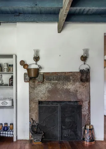 a room with a fireplace and cabinets