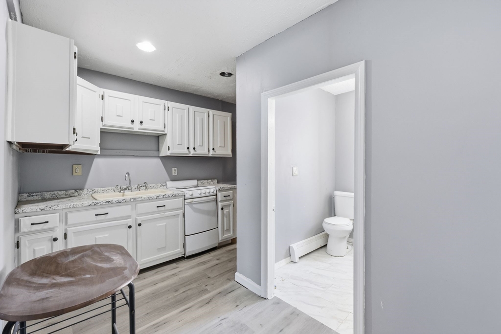 875 North Main Street Randolph, MA 02368 - Photo 14 of 42 a spacious bathroom with a granite countertop sink and a toilet