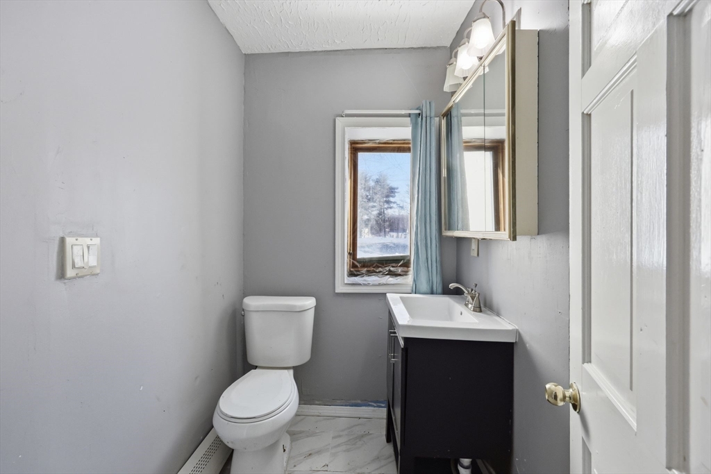 875 North Main Street Randolph, MA 02368 - Photo 18 of 42 a bathroom with a toilet sink and mirror