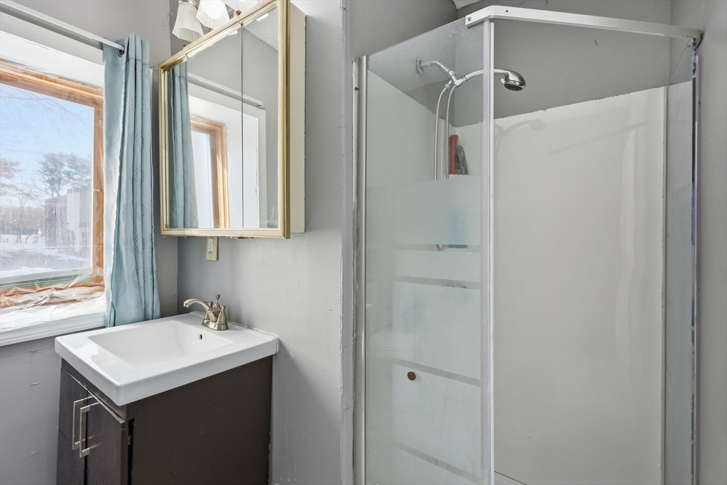 875 North Main Street Randolph, MA 02368 - Photo 19 of 42 a bathroom with a sink mirror and a shower