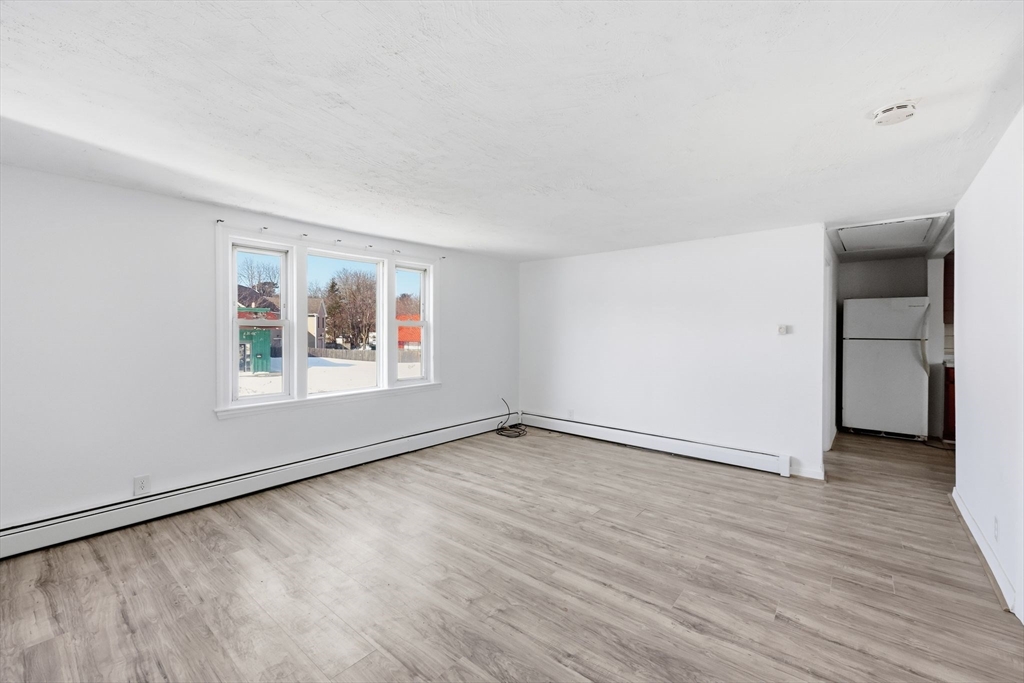 875 North Main Street Randolph, MA 02368 - Photo 21 of 42 an empty room with wooden floor and windows