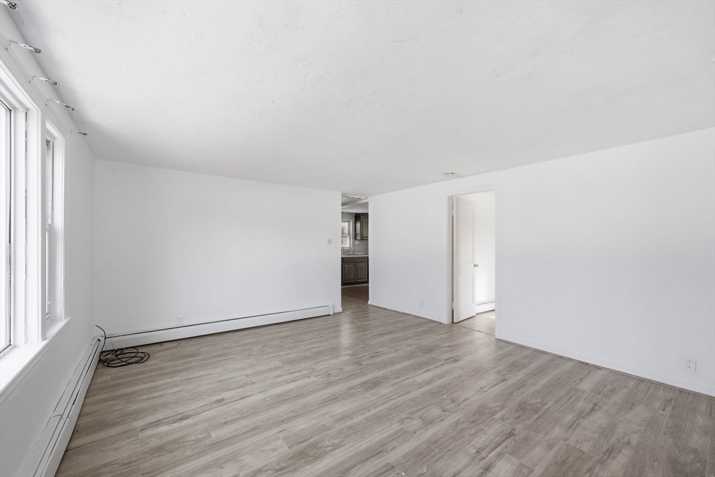 875 North Main Street Randolph, MA 02368 - Photo 22 of 42 an empty room with wooden floor and windows