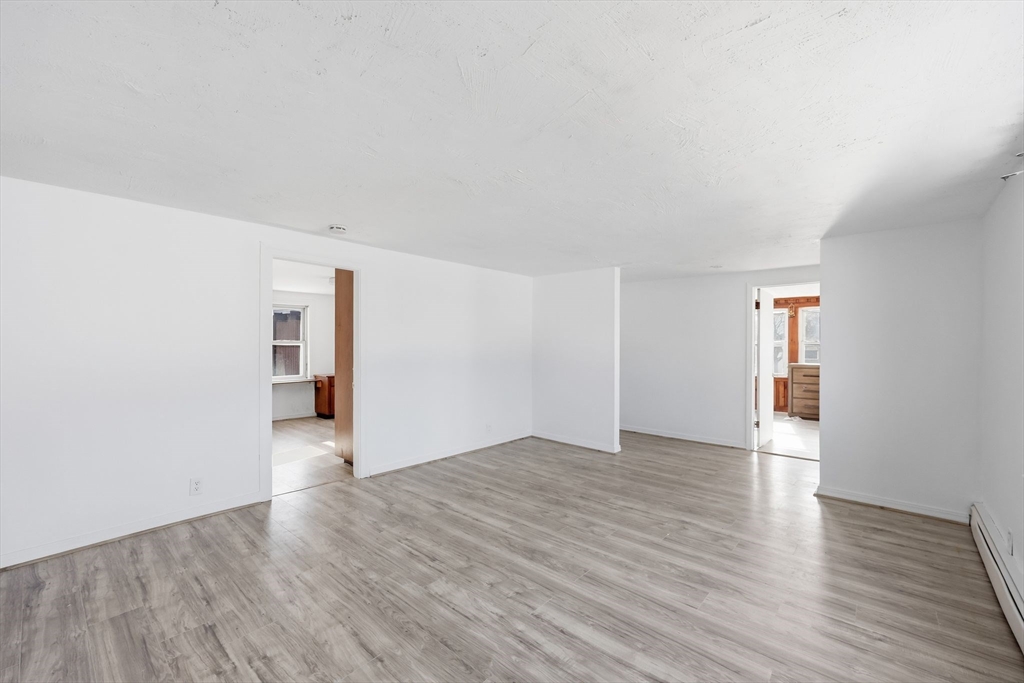 875 North Main Street Randolph, MA 02368 - Photo 23 of 42 a view of an empty room with window and wooden floor