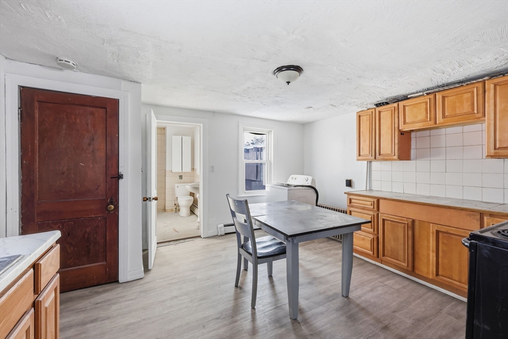 875 North Main Street Randolph, MA 02368 - Photo 26 of 42 a kitchen that has a table and chairs in it