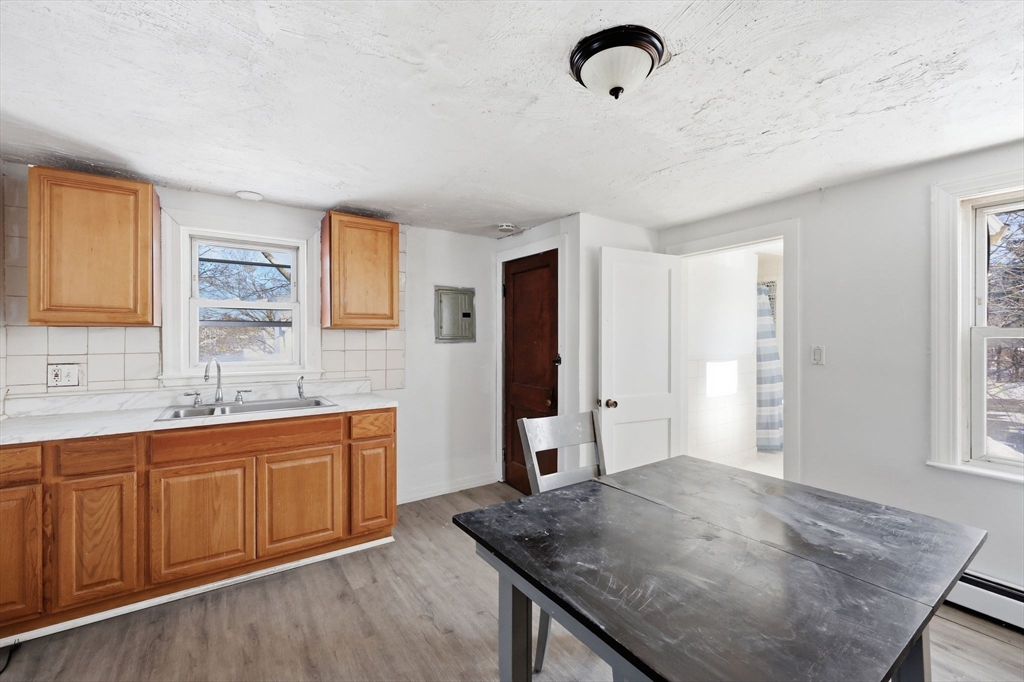 875 North Main Street Randolph, MA 02368 - Photo 29 of 42 a kitchen with stainless steel appliances granite countertop a sink dishwasher and refrigerator with wooden floor