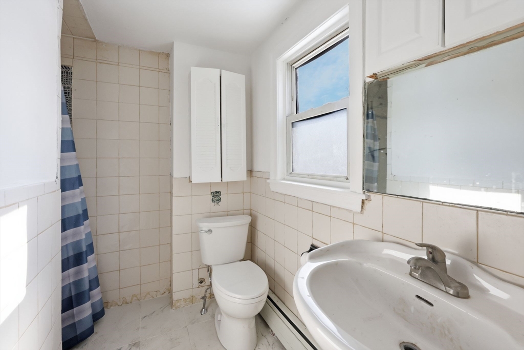 875 North Main Street Randolph, MA 02368 - Photo 37 of 42 a bathroom with a sink toilet and shower