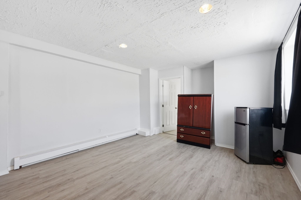 875 North Main Street Randolph, MA 02368 - Photo 5 of 42 a view of an empty room with a fireplace
