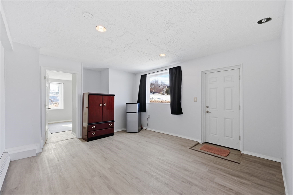 875 North Main Street Randolph, MA 02368 - Photo 6 of 42 a view of livingroom with hardwood floor and window