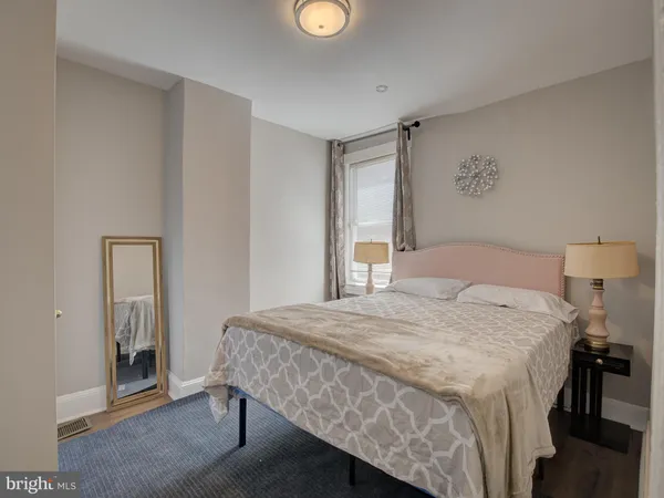 a bedroom with a bed and a mirror
