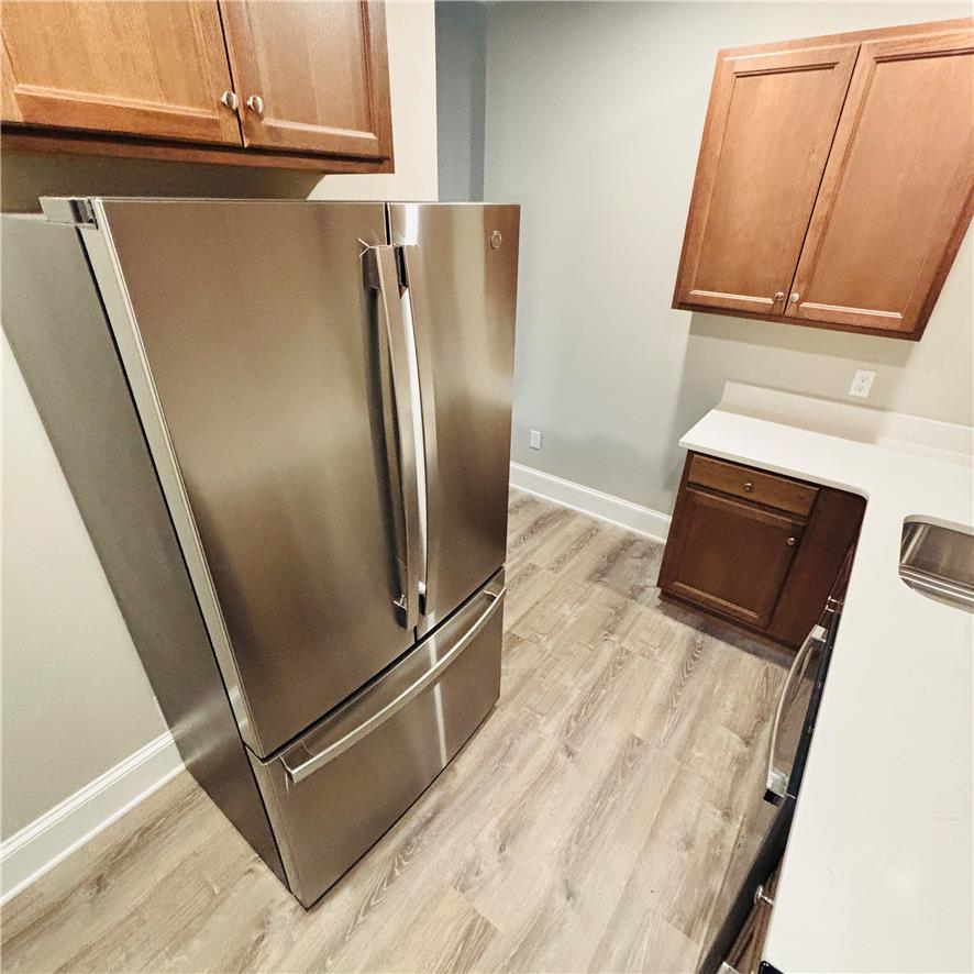 718 Linden Street Bethlehem, PA 18018 - Photo 8 of 19 A well-equipped kitchen space features a prominent stainless steel refrigerator and ample cabinetry.