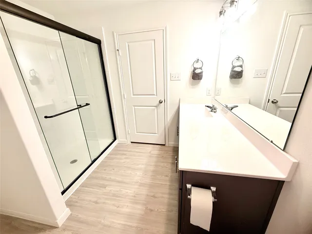 a view of empty room with wooden floor and cabinet