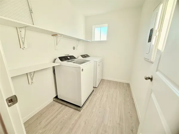 a bathroom with a sink a toilet a mirror and shower