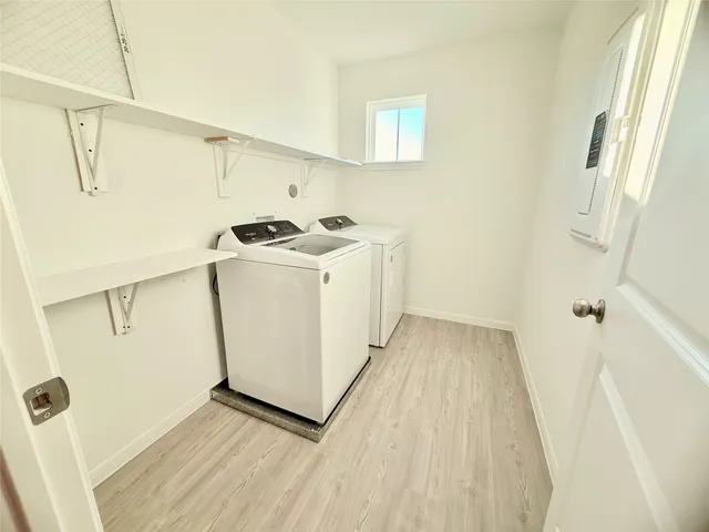 a bathroom with a sink a toilet a mirror and shower