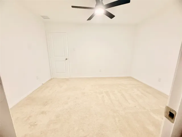 a view of a backyard with wooden fence