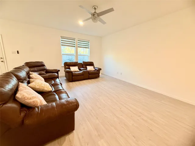 a kitchen with stainless steel appliances granite countertop a refrigerator a sink a stove a microwave and island