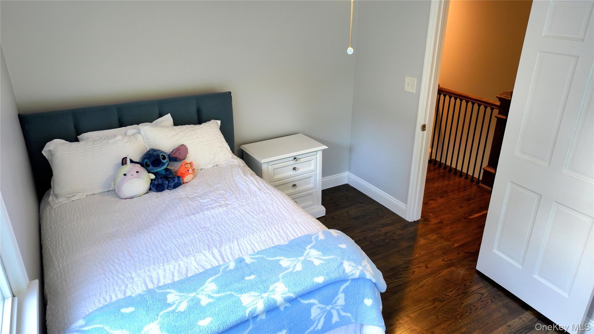 522 Moriches Road St. James, NY 11780 - Photo 30 of 49 a bedroom with a bed and wooden floor