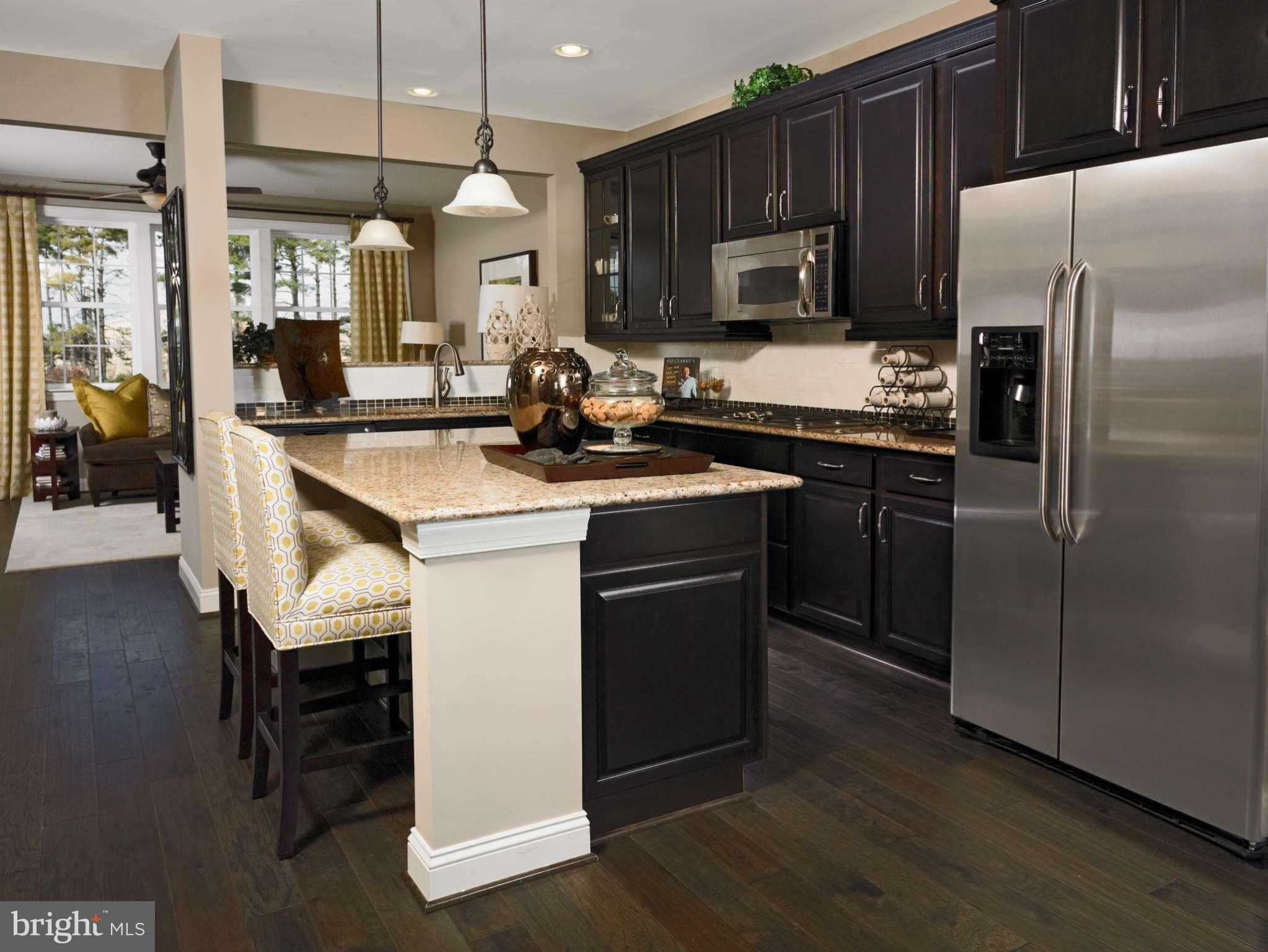 701 Holden Road Frederick, MD 21701 - Photo 3 of 6 a kitchen with a sink stainless steel appliances and wooden cabinets