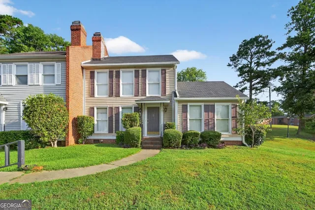 a front view of a house with garden